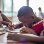 Boy writing on paper